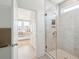 Tiled shower with a glass door is the focal point of this view into the ensuite bathroom and main bedroom at 421 Grove End Rd, Moncks Corner, SC 29461
