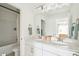 Bright bathroom featuring a double vanity, framed mirror and tub/shower at 421 Grove End Rd, Moncks Corner, SC 29461