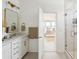 Bright bathroom features a glass shower, white vanity, gold accents, and access to the main bedroom at 421 Grove End Rd, Moncks Corner, SC 29461