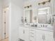 Modern bathroom featuring double vanity, framed mirrors, and updated lighting fixtures at 421 Grove End Rd, Moncks Corner, SC 29461