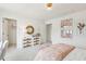 Stylishly decorated bedroom features a rattan dresser, cozy bed and trendy decor at 421 Grove End Rd, Moncks Corner, SC 29461