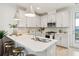 Modern kitchen boasts white cabinets, stainless steel appliances, and a functional island at 421 Grove End Rd, Moncks Corner, SC 29461