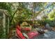Inviting backyard features a stone patio, fountain, lounge chairs, fire pit, and mature trees for outdoor living at 562 Fort Johnson Rd, Charleston, SC 29412