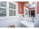 Charming bathroom with a white pedestal sink, classic fixtures, and wainscoting at 562 Fort Johnson Rd, Charleston, SC 29412