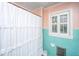 Bathroom featuring pastel colored walls, tiled walls, plantation shutters, and a vintage shower curtain at 562 Fort Johnson Rd, Charleston, SC 29412