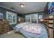 Comfortable bedroom with a bed, a chest of drawers, two windows letting in lots of light, and light-toned carpet at 562 Fort Johnson Rd, Charleston, SC 29412