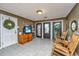 Inviting entrance area featuring tiled floors, rocking chairs, and decorative doors at 562 Fort Johnson Rd, Charleston, SC 29412