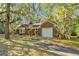 Charming brick home with mature trees, a private driveway and lush greenery all around the property at 562 Fort Johnson Rd, Charleston, SC 29412