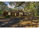 Charming brick home with mature trees, a private driveway and lush greenery all around the property at 562 Fort Johnson Rd, Charleston, SC 29412