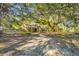 Charming brick home with mature trees, a private driveway and lush greenery all around the property at 562 Fort Johnson Rd, Charleston, SC 29412