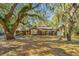 Charming brick home with mature trees, and a beautiful front yard landscape at 562 Fort Johnson Rd, Charleston, SC 29412