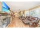 Spacious living room with hardwood floors, a stone fireplace, and comfortable leather seating at 562 Fort Johnson Rd, Charleston, SC 29412