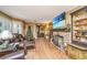 Spacious living room with hardwood floors, a stone fireplace, and custom shelving at 562 Fort Johnson Rd, Charleston, SC 29412