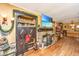 Spacious living room with hardwood floors, a stone fireplace, and a custom built-in at 562 Fort Johnson Rd, Charleston, SC 29412