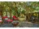 Backyard patio with comfortable seating, a water feature, and mature trees providing shade at 562 Fort Johnson Rd, Charleston, SC 29412