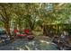 Serene backyard patio with comfortable seating, fountain, and surrounding lush trees at 562 Fort Johnson Rd, Charleston, SC 29412