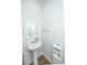 Powder room with a pedestal sink, framed mirror, and wood-look vinyl flooring at 607 Silver Spruce St, Summerville, SC 29486