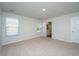 Bright bedroom featuring neutral carpet, one window with blinds, and an ensuite bathroom at 607 Silver Spruce St, Summerville, SC 29486