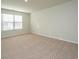 Bright bedroom featuring neutral carpet, one window with blinds, and light-colored walls at 607 Silver Spruce St, Summerville, SC 29486