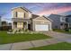 Charming two-story home with a well-manicured lawn and a two-car garage at 607 Silver Spruce St, Summerville, SC 29486