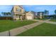 Beautifully landscaped front yard and exterior of a two-story home with a sidewalk at 607 Silver Spruce St, Summerville, SC 29486