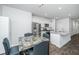 Well-equipped kitchen with stainless steel appliances, granite counters and adjacent dining area at 607 Silver Spruce St, Summerville, SC 29486