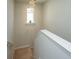 Stairway with a decorative chandelier, white banister, and a window with a plant at 607 Silver Spruce St, Summerville, SC 29486