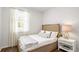 Bright bedroom with large window, bedside table and lamp and wood flooring at 6226 Gritman Dr, Hollywood, SC 29470