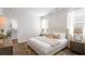 Comfortable bedroom with hard wood floors, bedside tables and neutral decor with view to bathroom at 6226 Gritman Dr, Hollywood, SC 29470