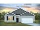 Charming one-story home featuring a two-car garage, neutral-colored siding, and a welcoming front entrance at 6230 Gritman Dr, Hollywood, SC 29470