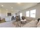 Open-concept living area showcasing a stylish couch, patterned rug, and natural light from the windows at 717 Pisces Ln, Summerville, SC 29486