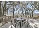 Back deck with table and chairs overlooking the water, surrounded by trees and greenery at 741 Creekside Dr, Mount Pleasant, SC 29464