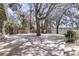 Expansive backyard deck featuring mature trees with hanging moss, overlooking the water at 741 Creekside Dr, Mount Pleasant, SC 29464
