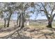 Picturesque backyard with a walkway leading to waterfront views, framed by moss-draped trees at 741 Creekside Dr, Mount Pleasant, SC 29464