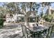 Backyard of home features a large deck with dining table, covered porch, and well-manicured landscape at 741 Creekside Dr, Mount Pleasant, SC 29464
