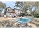 Home's backyard features a swimming pool, patio, and well-maintained landscape with mature trees at 741 Creekside Dr, Mount Pleasant, SC 29464