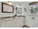 Elegant bathroom featuring a double vanity with granite countertops and decorative framed mirrors at 741 Creekside Dr, Mount Pleasant, SC 29464