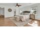 Bright and spacious bedroom showcasing hardwood floors, a comfortable bed, and ample natural light at 741 Creekside Dr, Mount Pleasant, SC 29464