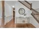 Inviting foyer with hardwood floors, elegant staircase, and stylish console table creates a warm and welcoming entrance at 741 Creekside Dr, Mount Pleasant, SC 29464