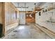 Functional garage space with wood-paneled walls, ample storage shelving, and an access door at 741 Creekside Dr, Mount Pleasant, SC 29464