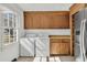 Bright laundry room features side-by-side washer and dryer, storage, and a window for natural light at 741 Creekside Dr, Mount Pleasant, SC 29464
