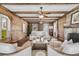 Bright living room with exposed beam ceilings, hardwood floors, brick fireplace, and ample seating with lots of natural light at 741 Creekside Dr, Mount Pleasant, SC 29464