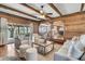 Spacious living room featuring wood paneling, exposed beams, and seamless flow to the outdoor living area at 741 Creekside Dr, Mount Pleasant, SC 29464
