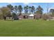 Spacious backyard featuring a brick house and a large grassy area perfect for recreation at 760 Community Ave, Smoaks, SC 29481