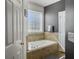 Ensuite bathroom featuring a soaking tub and decorative tile at 760 Community Ave, Smoaks, SC 29481