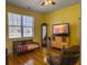 Bedroom featuring a window with lots of natural light, a TV, and wood floors at 760 Community Ave, Smoaks, SC 29481