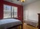 Bedroom features a four post bed, wood floors, and a window with bright natural light at 760 Community Ave, Smoaks, SC 29481