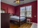 Bedroom featuring a four poster bed, wood floors and a window with natural light at 760 Community Ave, Smoaks, SC 29481