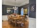 Elegant dining room features hardwood floors, a large wood table with seating for eight, decorative chandelier, and neutral tones at 760 Community Ave, Smoaks, SC 29481