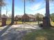 Charming brick home featuring a gated entrance, beautiful landscaping, and a well-maintained lawn at 760 Community Ave, Smoaks, SC 29481
